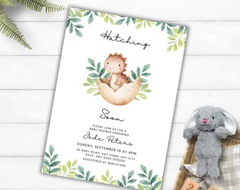 May include: A baby shower invitation with a watercolor illustration of a baby dinosaur hatching from an egg, surrounded by green leaves. The invitation reads "Hatching Soon" and includes event details.