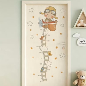 May include: A beige door decorated with a height chart featuring a cartoon pilot in an airplane. The chart includes a ladder, clouds, birds, and star accents, with measurements up to 150 cm.