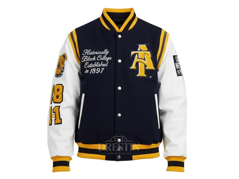 May include: A navy blue and white varsity jacket with yellow accents. The jacket features the text "Historically Black College Established de 1897" and a large "AT" logo. The sleeves have the numbers "18" and "11".