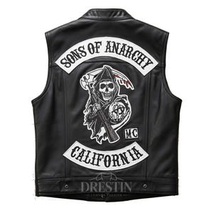May include: Black leather vest with the "Sons of Anarchy" logo on the back. The vest features a skull graphic with a scythe and the text "California". The vest has a button closure and the brand name "Drestin Leather Fashion" is visible.