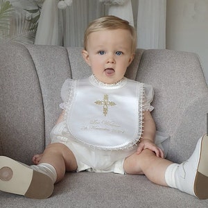 Gold intricate embroidery on a baby Baptism bib with matching accessories from www.lyubove.co.uk Lyubove Christenings