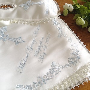 Blue intricate embroidery on a baby Baptism blanket with matching bib from www.lyubove.co.uk Lyubove Christenings