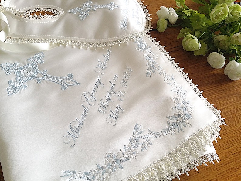Blue intricate embroidery on a baby Baptism blanket with matching bib from www.lyubove.co.uk Lyubove Christenings
