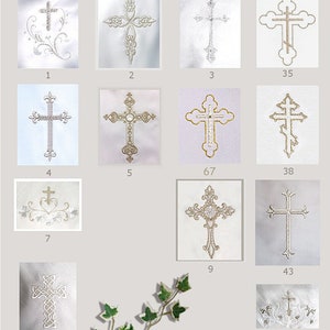 May include: A collection of embroidered crosses in various designs. The crosses are in different styles, with ornate details and embellishments. The color palette is primarily white and silver, with some gold accents. The crosses are displayed on a white background.