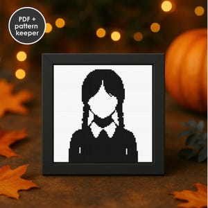 Puede incluir: Un retrato en punto de cruz enmarcado de un personaje con coletas negras, una cara blanca y un vestido negro. El marco es negro y el fondo es una mezcla borrosa de naranja y marrón. El texto "PDF + pattern keeper" está en la esquina superior izquierda.