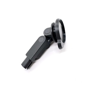May include: A dark gray, adjustable device with a circular head and a segmented arm. The head has a raised, circular rim. The arm has two hexagonal joints. The base has a slotted end. The device is set against a white background.