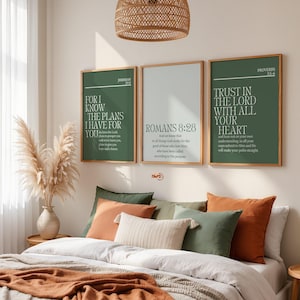 May include: Three framed wall art prints with inspirational quotes in a bedroom setting. The prints feature text on a green and white background. The room includes a bed with pillows and a woven pendant light.