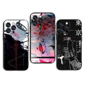 May include: Three phone cases with distinct designs. One case has a black and white abstract design, another shows a close-up of a character with red eyes and the text "TOKYO GHOUL", and the third displays a cityscape with Japanese text.