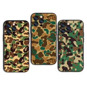 May include: Three phone cases with a camouflage pattern in shades of green, brown, and tan. The cases have a glossy finish and a black border. Each case has a camera cutout.