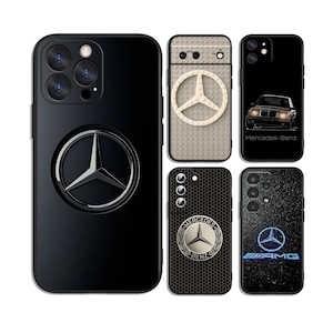 May include: Five smartphone cases featuring Mercedes-Benz branding. One large black case has a central silver logo. Others include a beige brick-textured case with a logo, a black case with a car graphic, a black honeycomb case, and a textured black AMG case.