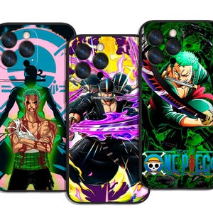 May include: Three phone cases with anime character designs. The cases show colourful illustrations of a character with green hair, a character with black hair, and a character with green hair holding a sword. The cases have a black border.