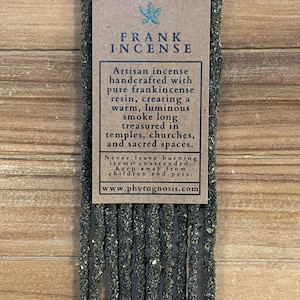 May include: A bundle of dark, textured incense sticks with a brown paper label featuring the text FRANK INCENSE, a leaf icon, and a description of the product as handcrafted with pure frankincense resin, including safety warnings and a website.