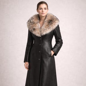 Elegant woman wearing a long black sheep leather coat with real fox fur collar, button front luxury winter coat shown in studio lighting