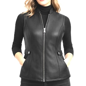 Black women’s genuine leather vest, tailored slim fit with stand collar, full front zipper, smooth finish, studio product photo on white background.