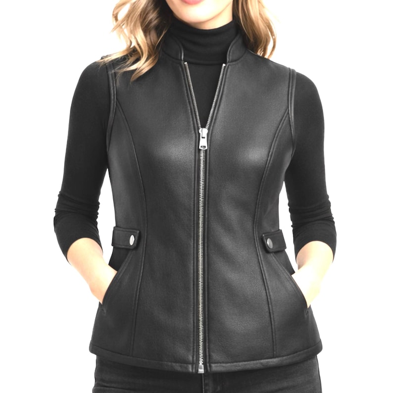 Black women’s genuine leather vest, tailored slim fit with stand collar, full front zipper, smooth finish, studio product photo on white background.