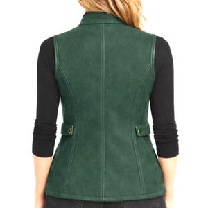 Back view of forest green women’s leather vest on model, smooth leather finish with tailored seam lines, minimalist studio photo, Anabia Leather Co.