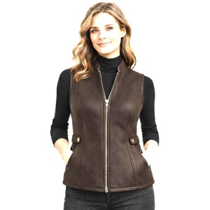 Women wearing dark brown leather vest, zip front with stand collar, fitted waist shaping and side tabs, premium e-commerce studio photo, Anabia Leather Co.