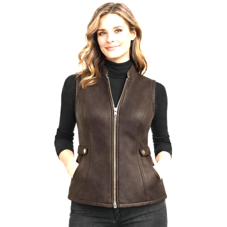 Women wearing dark brown leather vest, zip front with stand collar, fitted waist shaping and side tabs, premium e-commerce studio photo, Anabia Leather Co.