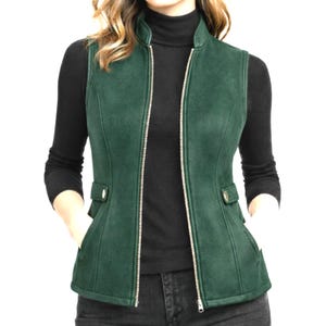Women wearing forest green leather vest with open zipper, tailored slim fit over black turtleneck, elegant studio e-commerce photo for Etsy, Anabia Leather Co.
