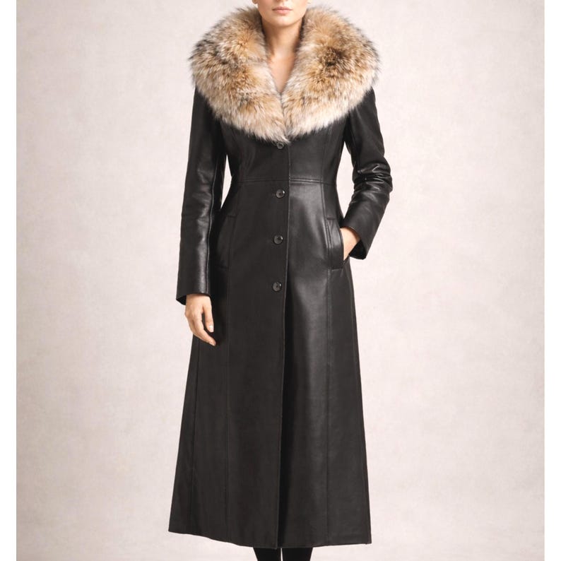 Elegant woman wearing a long black sheep leather coat with real fox fur collar, button front luxury winter coat shown in studio lighting
