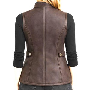 Back view of dark brown women’s leather vest on model, slim fit tailored panels, clean back seams, studio product lifestyle look, Anabia Leather Co.
