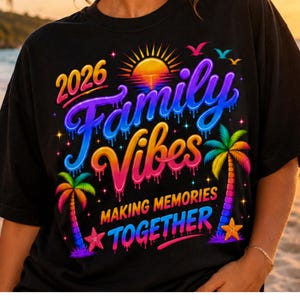 May include: Black t-shirt with a colorful graphic that reads "2026 Family Vibes Making Memories Together." The design includes a sunset, palm trees, and a starfish, with vibrant colors like blue, purple, orange, and pink.