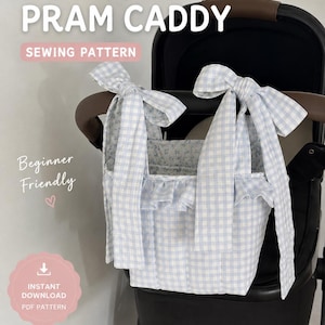 May include: A light blue and white gingham fabric pram caddy featuring long tie-top straps and a ruffled trim. The caddy is attached to a black pushchair. Text on the image reads: BOW PRAM CADDY, SEWING PATTERN, Beginner Friendly, INSTANT DOWNLOAD PDF PATTERN.