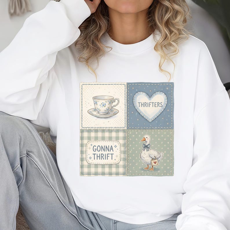 May include: White sweatshirt featuring a patchwork design with a teacup, heart with "Thrifters" text, and a goose with a bow tie and a heart-shaped bag. The bottom left patch reads "Gonna Thrift."