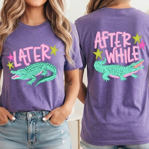 May include: Purple t-shirts with a teal alligator graphic and the words "LATER" and "AFTER WHILE" in pink and white. The alligator has pink accents and is surrounded by yellow and pink stars.