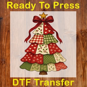 May include: A Christmas tree design with a patchwork pattern in red, green, and white. The tree is topped with a red bow and a gold star. The words "Ready To Press" and "DTF Transfer" are displayed.