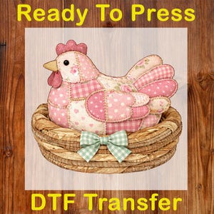 May include: A patchwork hen in a woven basket, with a green and white checkered bow. The hen is pink and white with floral and polka dot patterns. The text "Ready To Press" and "DTF Transfer" are in yellow.