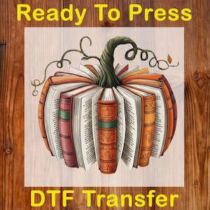 May include: A DTF transfer featuring a pumpkin design made of open books. The books are orange, red, and brown with green spines and a green stem. The text "Ready To Press" and "DTF Transfer" are in yellow.