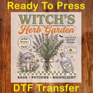 May include: A square DTF transfer sheet featuring the text Ready To Press at the top and DTF Transfer at the bottom. The design displays the text Witch's Herb Garden, a bundle of herbs, mushrooms, a potion bottle, and the words Sage, Potions, Moonlight.