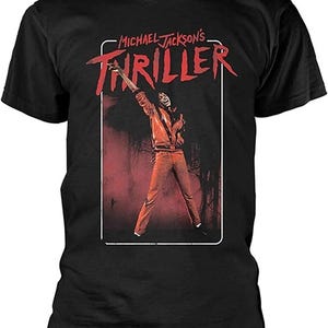 May include: Black t-shirt featuring a graphic of Michael Jackson from the Thriller music video. The image shows Jackson in a red outfit with the word "Thriller" in red text. The shirt is a classic crew neck style.