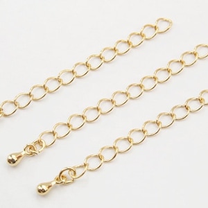 May include: Three gold chain extenders with small round ball ends. The chains are made of small, linked circles.