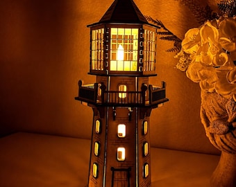 May include: A decorative lighthouse lamp featuring a multi-level structure with a pointed roof, a railed balcony, and multiple rectangular windows. The structure is illuminated from within, casting a warm, golden glow through the window panes.