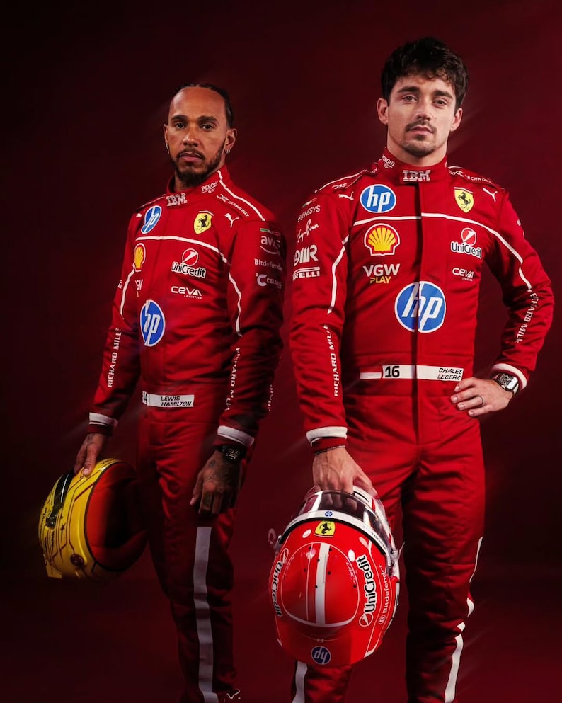 May include: Two Formula 1 drivers in red racing suits with white accents and sponsor logos. One holds a yellow and red helmet, the other a red helmet. The suits feature the IBM, HP, and UniCredit logos. The background is a deep red.