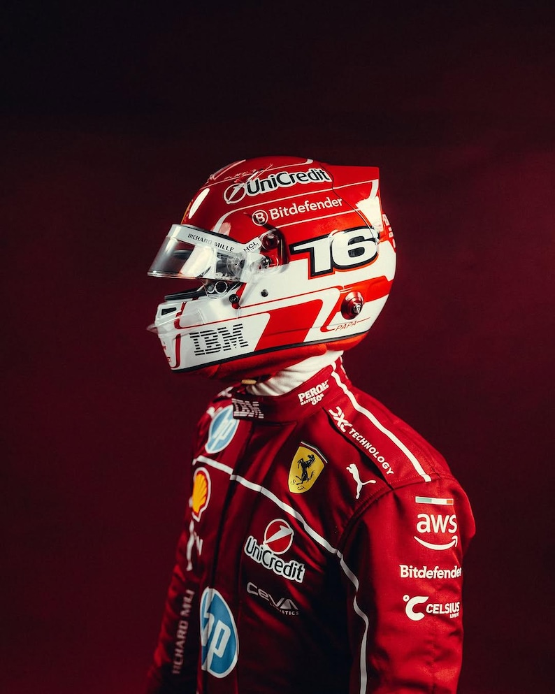 May include: A red and white racing helmet with the number 16, and sponsor logos including UniCredit, Bitdefender, and IBM. The helmet is worn with a red racing suit featuring additional logos and branding.