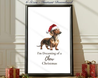 May include: Framed print featuring a dachshund wearing a Santa hat. The dog is brown and tan, with the text "I'm Dreaming of a Chew Christmas" below. The print is in a black frame.