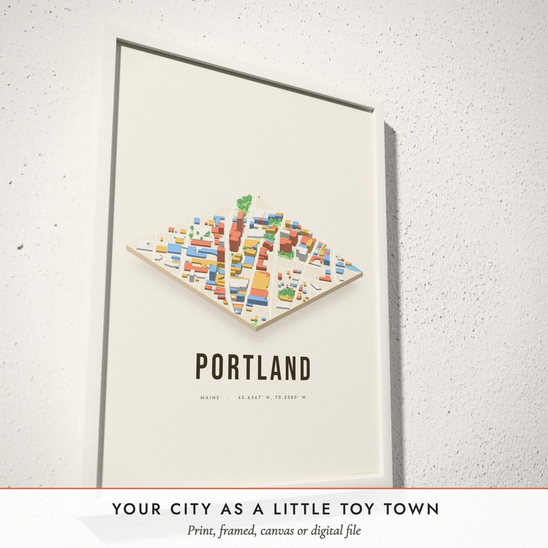 Three-quarter view of the framed Isometric City Map poster on a white plaster wall