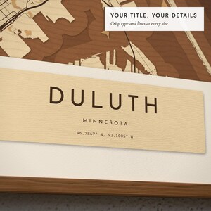 Close-up of the personalized title and details on the Layered Wood City Map print