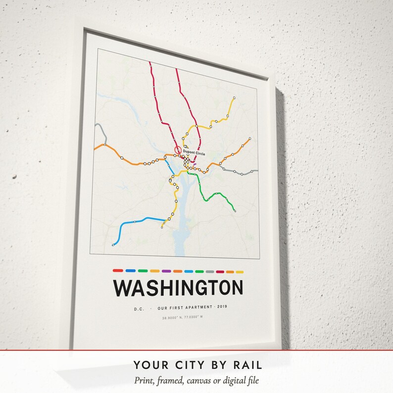 Three-quarter view of the framed Metro Line Map poster on a white plaster wall