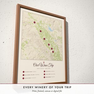 Three-quarter view of the framed Wine Country Map poster on a white plaster wall