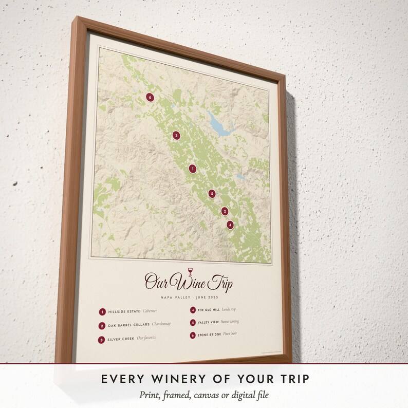 Three-quarter view of the framed Wine Country Map poster on a white plaster wall