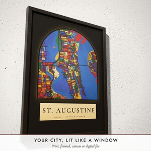 Three-quarter view of the framed Stained Glass City Map poster on a white plaster wall