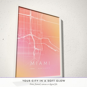 Three-quarter view of the framed Aura City Map poster on a white plaster wall