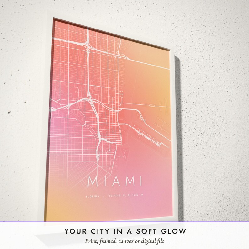 Three-quarter view of the framed Aura City Map poster on a white plaster wall