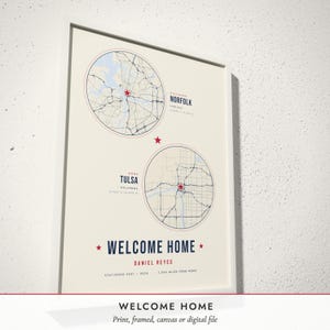 Three-quarter view of the framed Military Homecoming Map poster on a white plaster wall