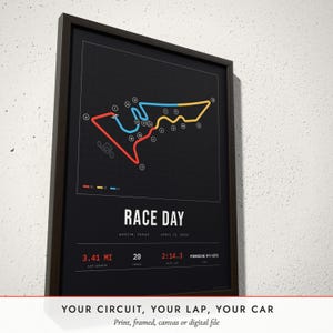 Three-quarter view of the framed Race Track Map poster on a white plaster wall