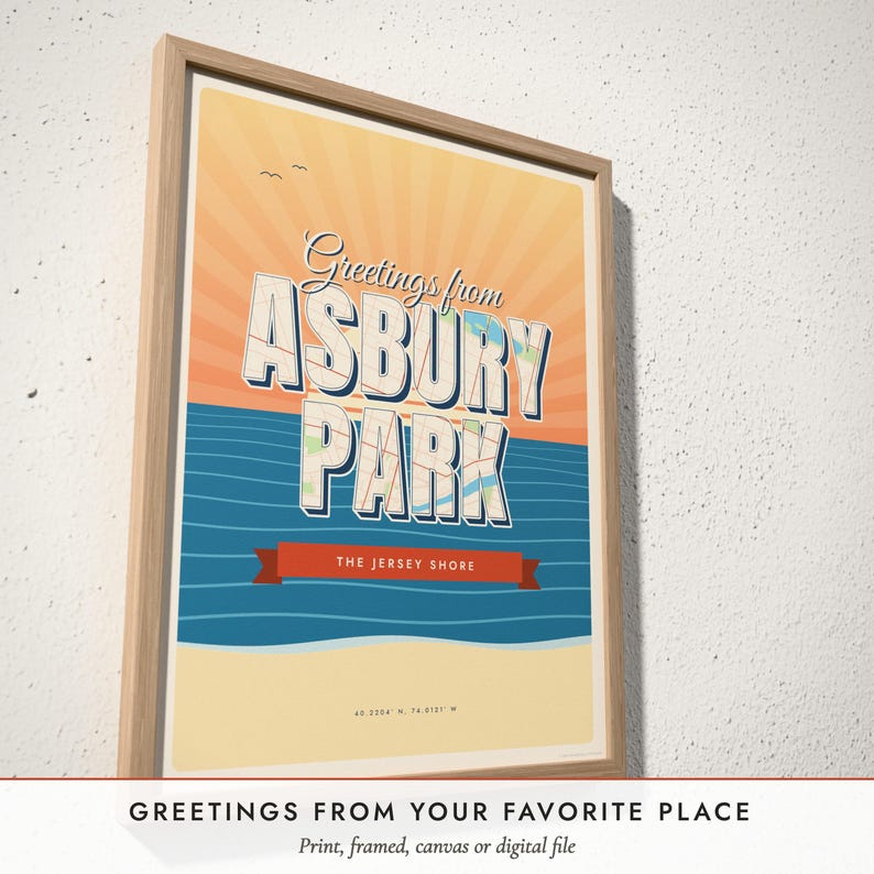 Three-quarter view of the framed Greetings From Postcard Map poster on a white plaster wall